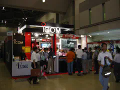 Icom booth showing IC-R5 handheld receiver and IC-756 Pro II displays.