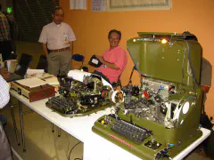 JA9LX and JA1JDD behind the Japan Amateur Radio Teleprinter Society booth with some of their "RTTY museum"