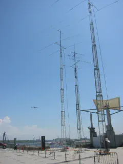 8J1A antenna farm, overlooking Tokyo Bay, with plane on the short base turn  into Haneda Airport